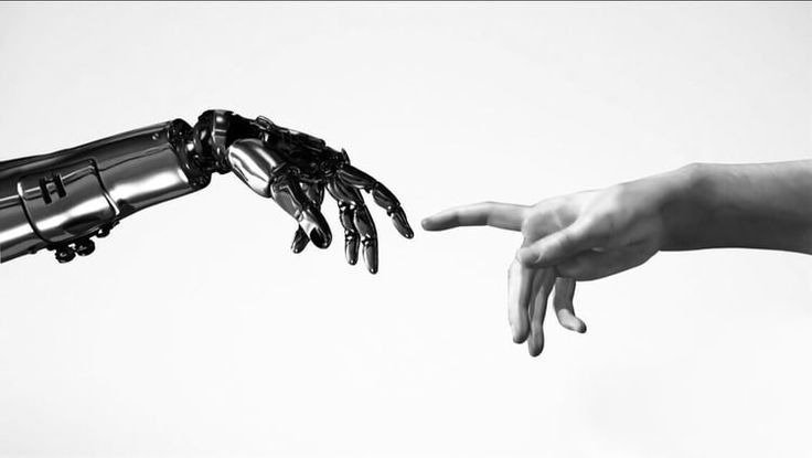 A robotic hand and a human hand reaching toward each other